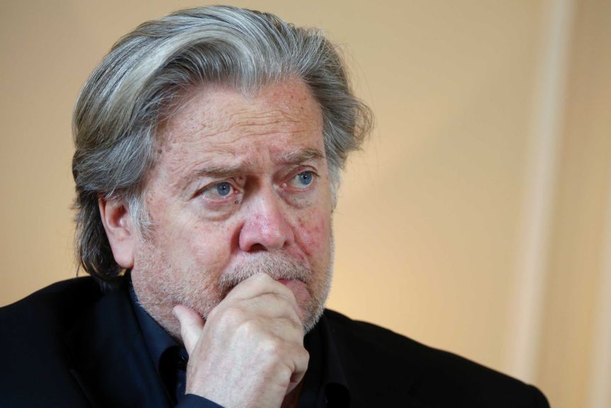 Close up of Steven Bannon's head as he looks to the right while wearing a black turtleneck