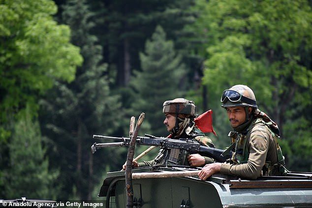 Indian army soldiers sit in military vehicle after June violence, worst border fighting with China in 53 years