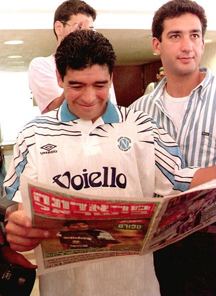 Diego Maradona reads a newspaper