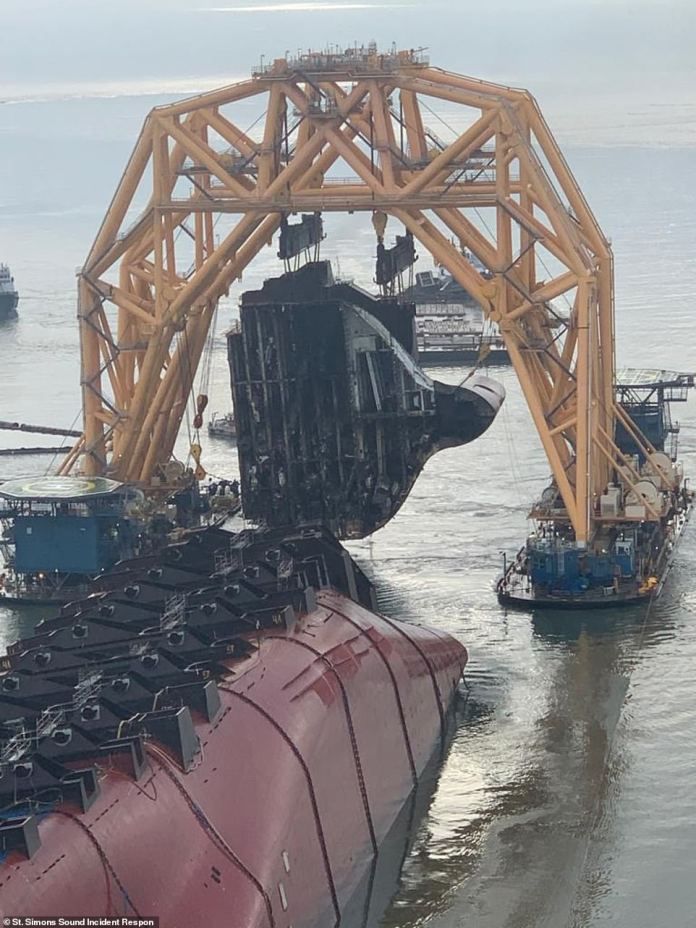 A 400-foot anchor chain is used to cut sections, exposing the many Hyundai cars trapped inside the ship