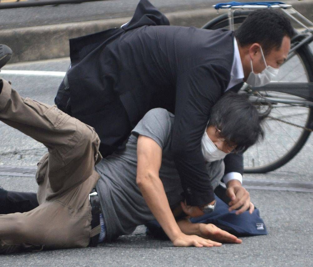 A man, believed to be a suspect shooting Japanese Prime Minister Shinzo Abe is held by police officers at Yamato Saidaiji Station in Nara, Nara Prefecture on July 8, 2022 in this photo taken by the Yomiuri Shimbun. — The Yomiuri Shimbun/KYODO via Reuters