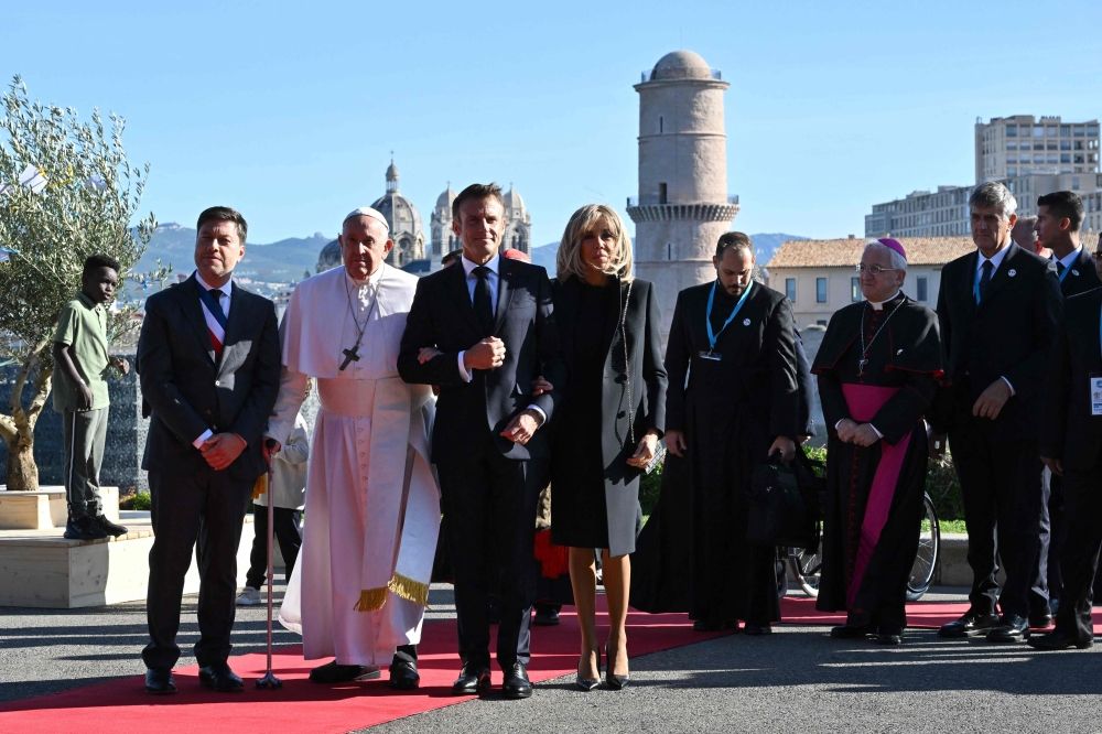 The Mayor of Marseille Benoit Payan (left) stands next to the Pope Francis (second left) as the Pope and the wife of the French President Brigitte (right to centre) take the arm of French President Emmanuel Macron (second right to centre), upon the Pope’s arrival at the Palais du Pharo in the southern port city of Marseille on September 23, 2023. — AFP pic