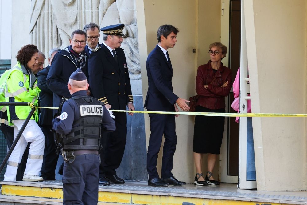 French Education and Youth Minister Gabriel Attal (second right) arrives at the Gambetta high school in Arras, north-eastern France on October 14, 2023, the day after a teacher was killed and two other people severely wounded in a knife attack. — AFP pic