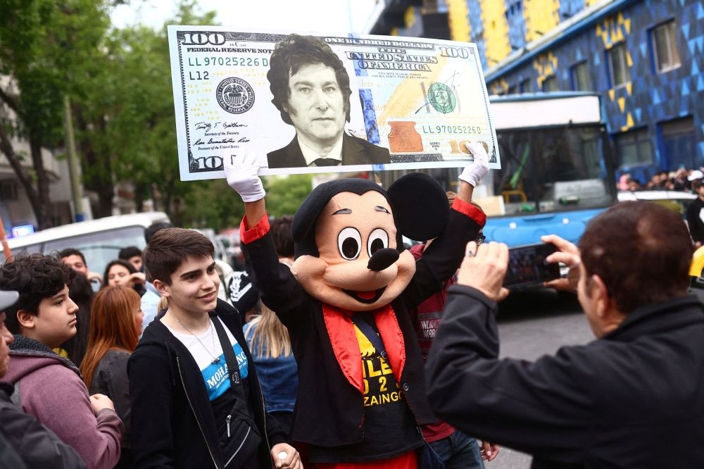 A person dressed as Mickey Mouse holds a giant mock bill with the face of Argentine presidential candidate Javier Milei of La Libertad Avanza party on the day of Milei closing his electoral campaign ahead of the presidential election, in Buenos Aires October 18, 2023. — Reuters pic