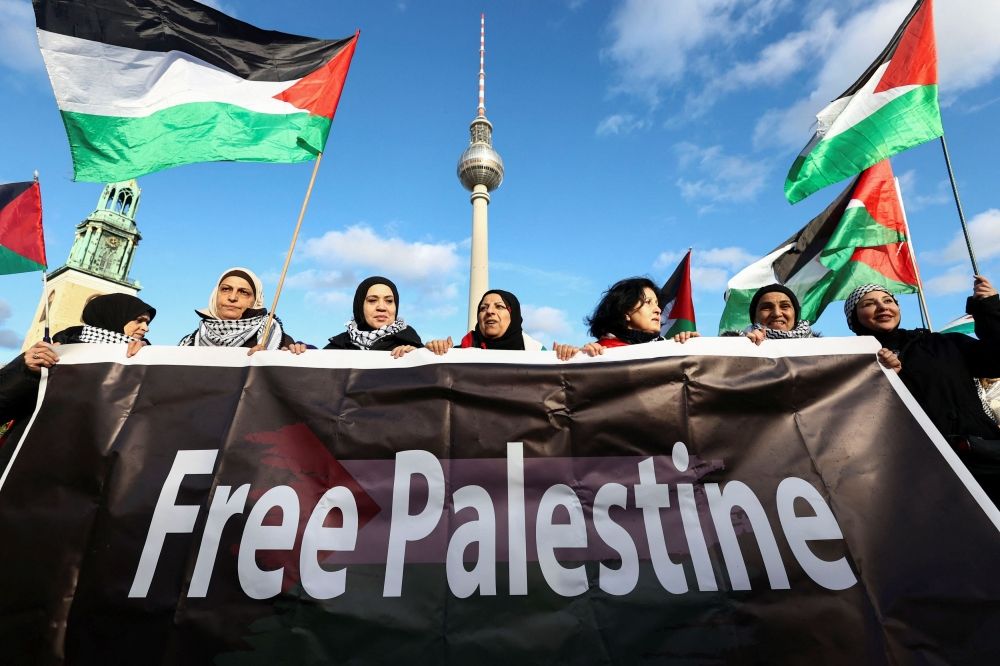People hold a banner during a pro-Palestinian demonstration, amid the ongoing conflict between Israel and Palestinian Islamist group Hamas, near the TV Tower, in Berlin, Germany, November 4, 2023. — Reuters pic
