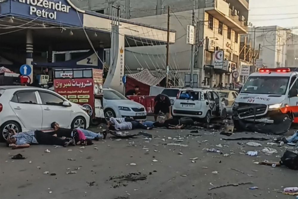 This image grab taken from an AFPTV video footage shows victims lying near an ambulance damaged in a reported Israeli strike in front of Al-Shifa hospital in Gaza City on November 3, 2023, as battles between Israel and the Palestinian Hamas movement continue. — AFP pic