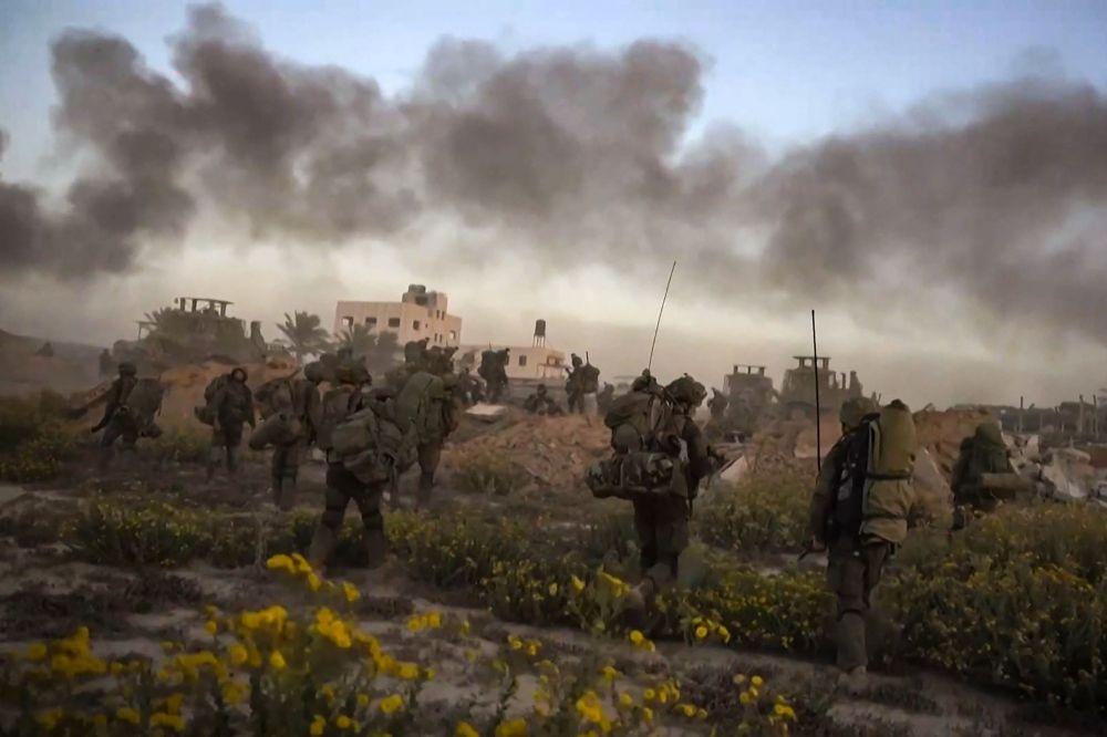 This file photo from a handout video released by the Israeli army on November 11, 2023, shows smoke rising as Israeli forces patrol inside the Gaza Strip. ― AFP pic