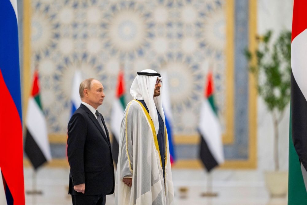 A handout picture provided by the UAE Presidential Court shows President of the United Arab Emirates Sheikh Mohammed bin Zayed Al-Nahyan (right) and Russian President Vladimir Putin stand during a welcome ceremony at Qasr Al-Watan palace in Abu Dhabi December 6, 2023. — UAE Presidential Court/AFP pic