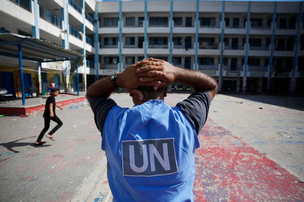 A United Nations' volunteer stands in the yard of a UN-run school in the refugee camp of Al-Maghazi in the central Gaza Strip October 18, 2023. — AFP pic