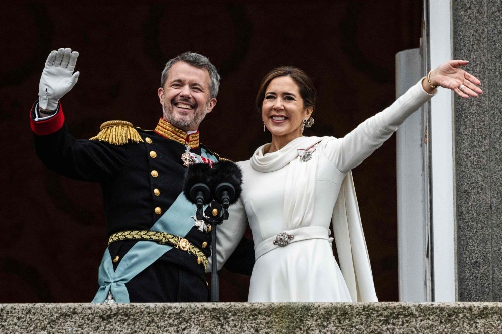 King Frederik X of Denmark and Queen Mary of Denmark wave on the balcony of Christiansborg Palace in Copenhagen, Denmark on January 14, 2024. — AFP pic