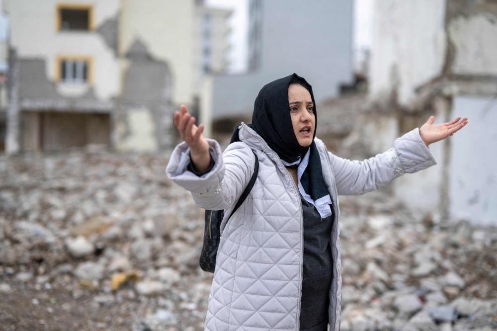 Tuba Erdemoglu, 35, gestures next to the rubble of her apartment in Kahramanmaras, on January 18, 2024. — AFP pic