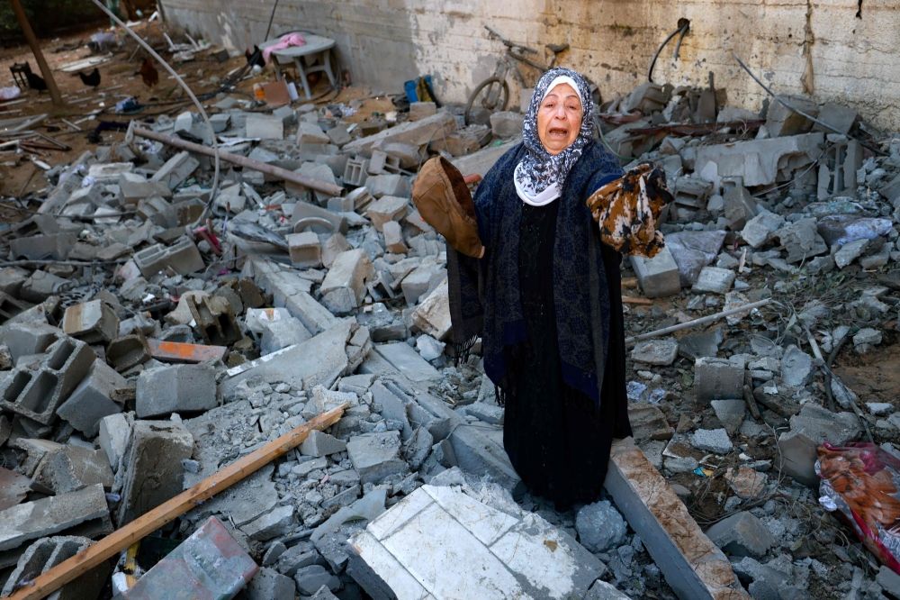A woman reacts as she salvages belongings from the rubble of a destroyed house following Israeli bombardment in Rafah in the southern Gaza Strip on February 3, 2024, as fighting continues between Israel and the Palestinian Hamas group. — AFP pic