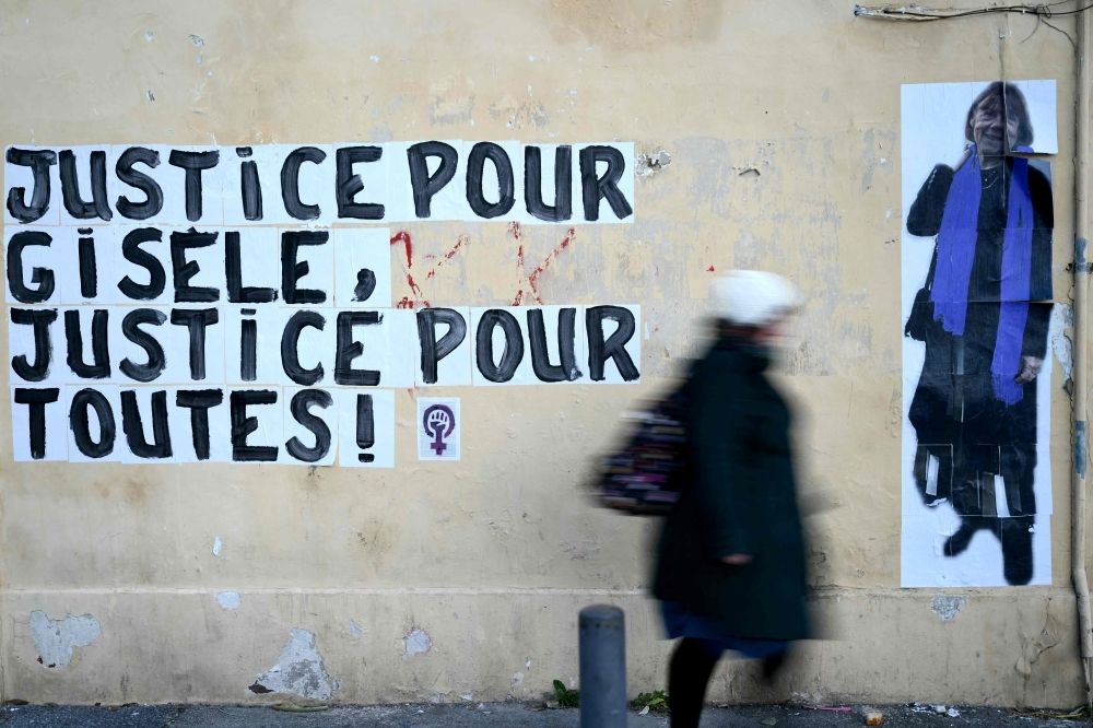 France helpline offers support for victims of drug-facilitated sexual assault amid shock mass rape trial revelations A pedestrian walks past a collage on a wall displaying the message