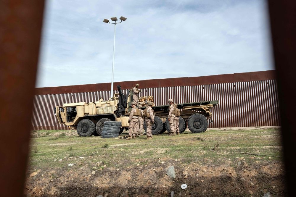 US Marine Corps members are pictured as they work on reinforcing the border wall at El Nido de las Aguilas in eastern Tijuana, Baja California State, Mexico, on March 5, 2025, seen from the Mexican side of the Mexico-US border. — AFP pic