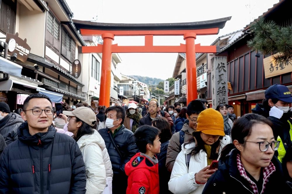 In Japan, Israeli tourist asked to sign war crimes form in Kyoto guesthouse Tourists walk past shops during a visit to Fushimi Inari Shrine in the city of Kyoto on January 13, 2025. An Israeli tourist was asked to sign a declaration denying involvement in war crimes when checking into a guesthouse in Kyoto earlier this month, prompting a formal protest from Israel’s ambassador to Japan. — AFP pic