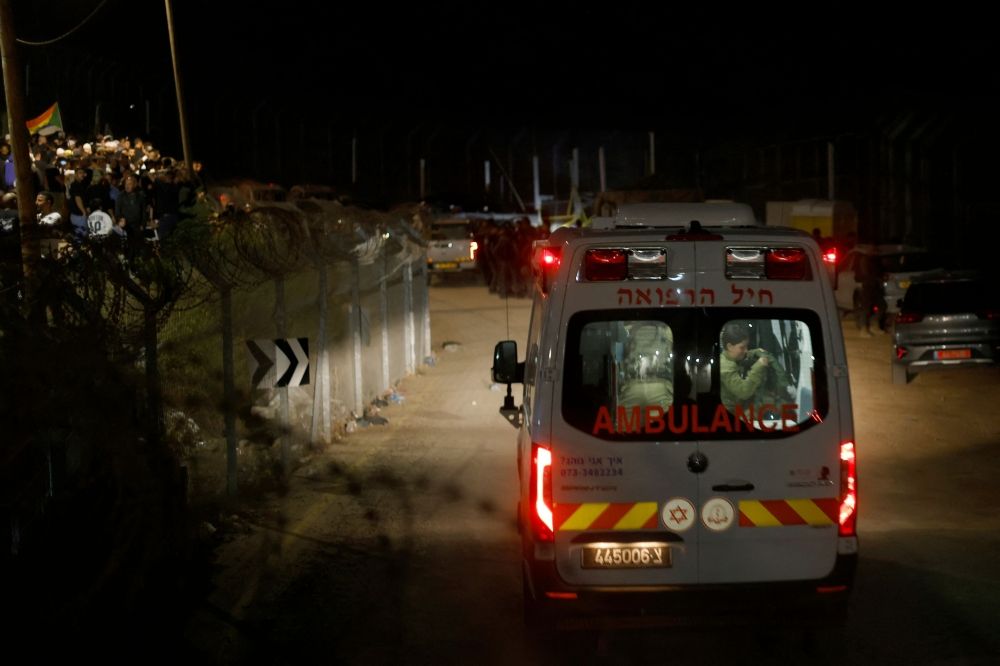 An Israeli military ambulance transporting injured Syrian Druze to an Israeli hospital crosses the border fence near the Druze village of Majdal Shams in the Israel-annexed Golan Heights on April 30, 2025. — AFP pic
