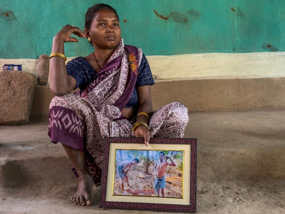This photograph taken on March 14, 2025, shows Somari Negi, wife of Rameshwar Negi who was killed last year by the police suspecting him as a rebel, holding a photo frame of her husband while speaking with AFP during an interview in Marda village, in Bastar division of India’s Chhattisgarh state. — AFP pic