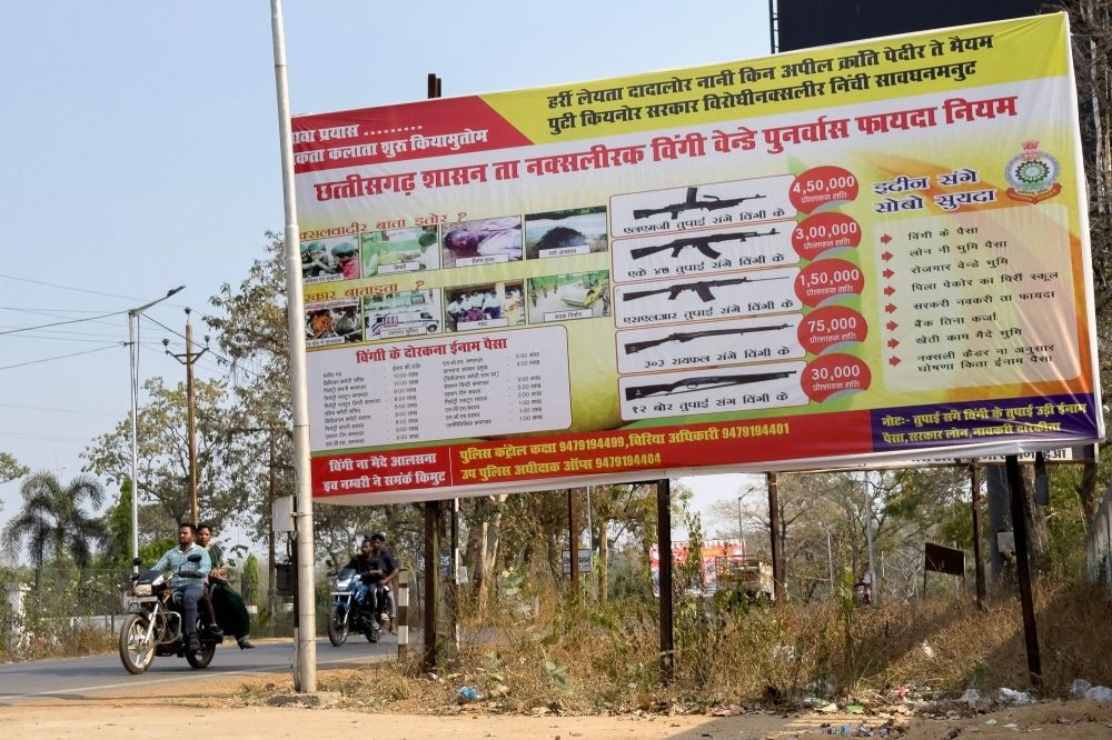 This photograph taken on March 9, 2025, shows a police-sponsored hoarding offering rewards to locals for information on Naxals and rewards for rebels upon their surrender, in Bijapur, in India’s Chhattisgarh state. — AFP pic