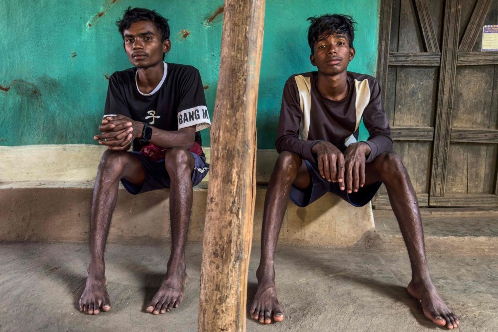 This photograph taken on March 14, 2025, shows Kailash Negi (left) and Khemraj Negi, sons of Rameshwar Negi who was killed last year by the police suspecting him as a rebel, posing for a photo at their home in Marda village, in Bastar division of India’s Chhattisgarh state. — AFP pic