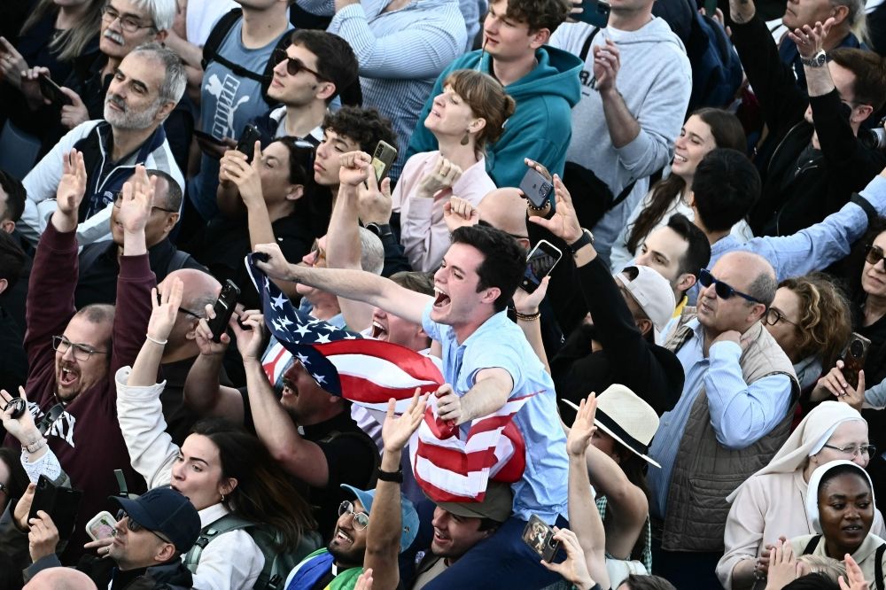 A man waves a US flag on St Peter's Square as the newly elected pope is announced in The Vatican, on May 8, 2025. — AFP pic