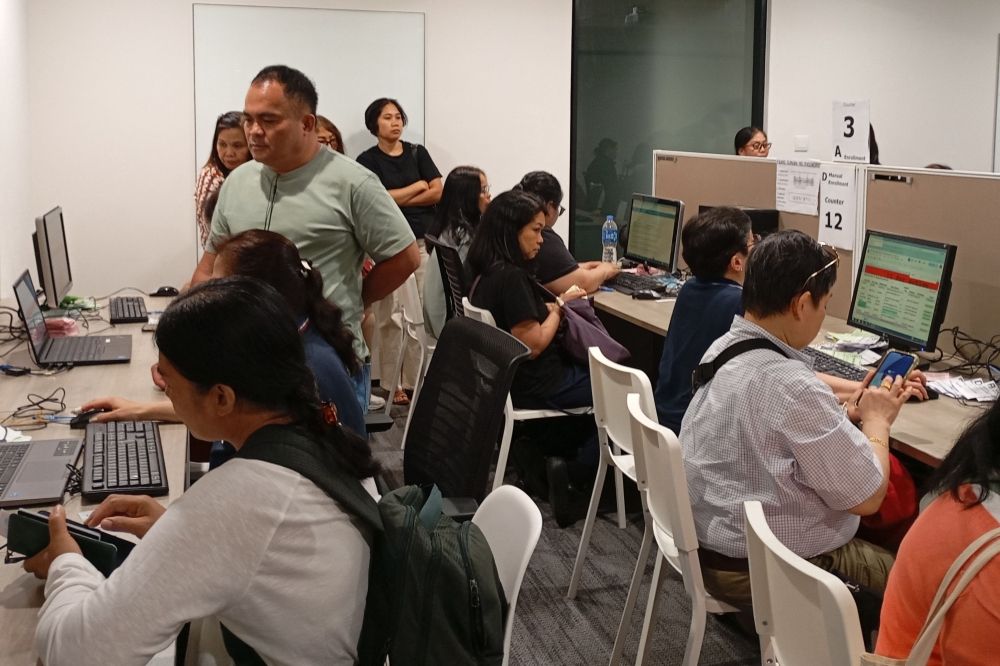 In this picture taken on May 4, 2025, overseas Filipino workers cast their votes online at the Philippine Consulate in Hong Kong. — AFP pic