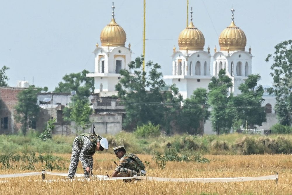 Soldiers inspect the debris of a missile at a field on the outskirts of Amritsar on May 8, 2025. — AFP pic