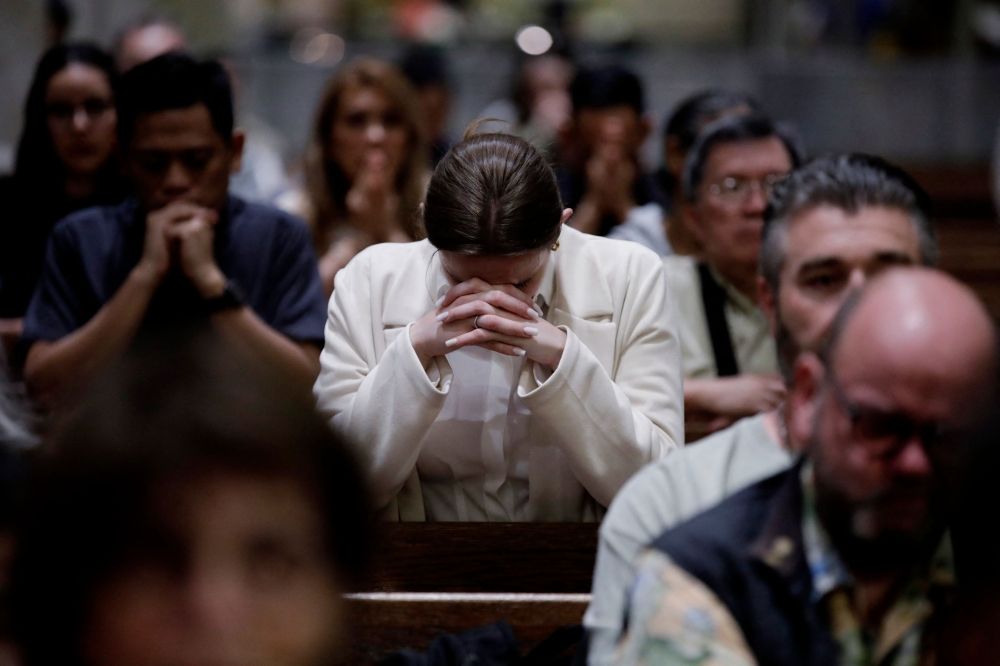 People attend a mass after the selection of newly elected Pope Leo XIV, Robert Prevost at Saint Patrick's Cathedral in New York City on May 8, 2025. — AFP pic