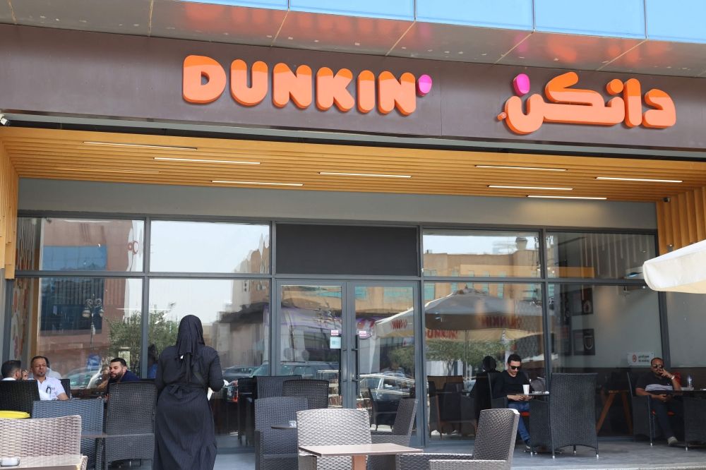Saudis and foreigners sit at Dunkin coffee shop in Riyadh on May 1, 2025. — AFP pic