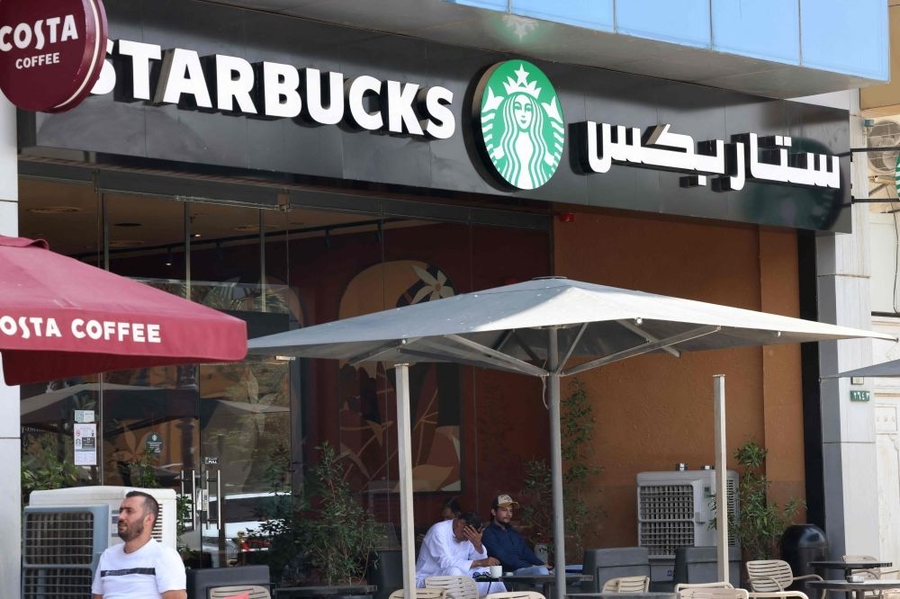 Beyond the veil: Saudi Arabia’s surprising love affair with Dunkin’ Donuts and US culture People sit at a Starbucks coffee shop in Riyadh on May 1, 2025. — AFP pic