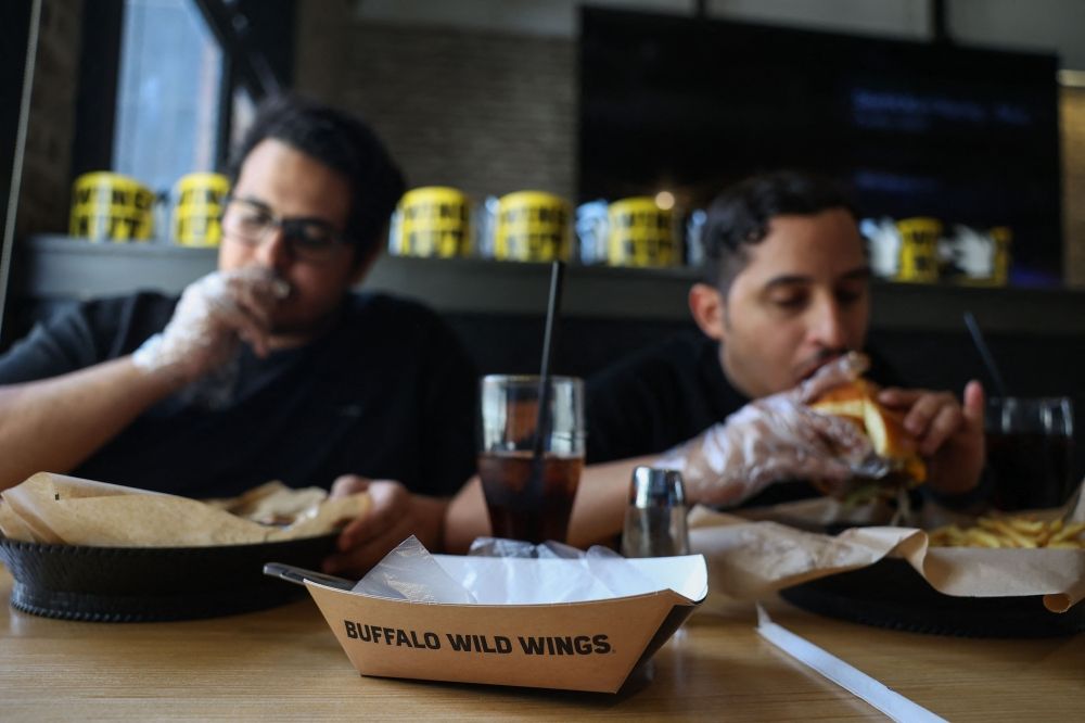 Saudis have a meal at a branch of the US restaurant 'Buffalo Wild Wings' in Riyadh on May 1, 2025. — AFP pic