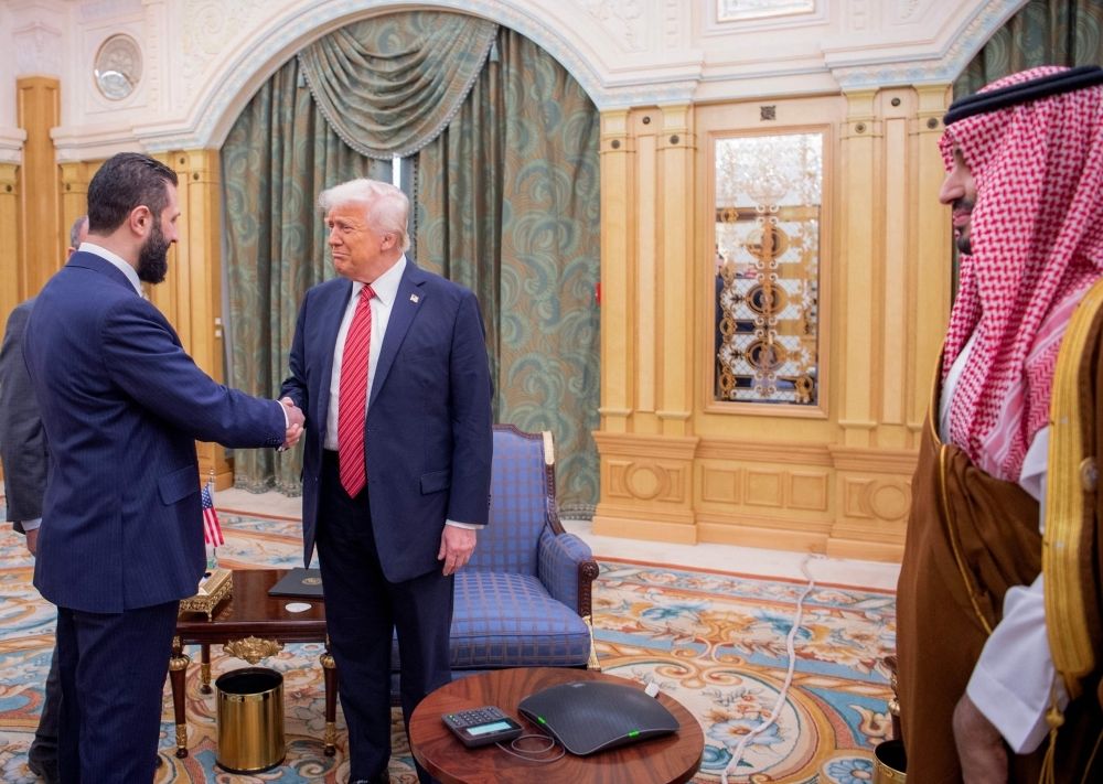 After lifting sanctions on Syria, Trump urges new leader to normalise ties with Israel A handout picture provided by the Saudi Royal Palace shows Saudi Crown Prince Mohammed bin Salman (R) watching as US President Donald Trump (C) shakes hands with Syria's interim president Ahmed al-Sharaa in Riyadh May 14, 2025. — AFP pic