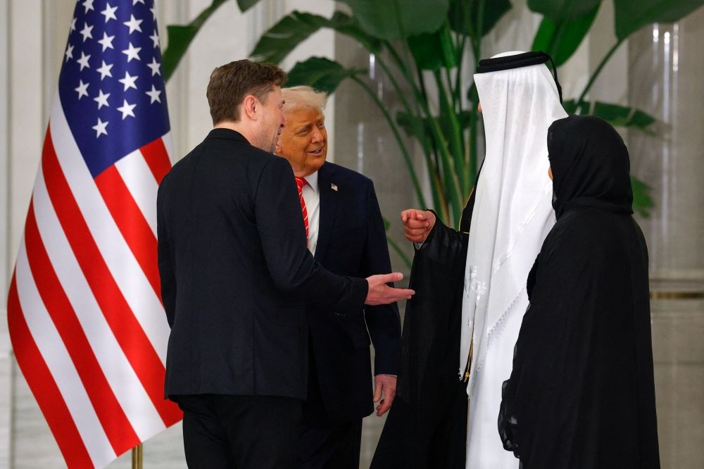 US President Donald Trump speaks with Tesla CEO Elon Musk and Qatar's Emir Tamim bin Hamad Al Thani ahead of a state dinner at Lusail Palace in Lusail, Qatar, May 14, 2025. — Reuters pic