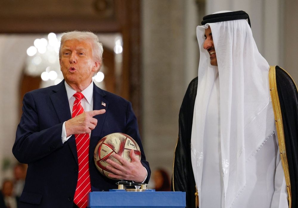 Inside Trump’s luxury jet scandal and crypto empire fuelling new ethics storm US President Donald Trump holds a soccer ball as he attends an event with Qatar's Emir Tamim bin Hamad Al Thani and FIFA President Gianni Infantino (not pictured), at Lusail Palace in Lusail, Qatar, May 14, 2025. — Reuters pic