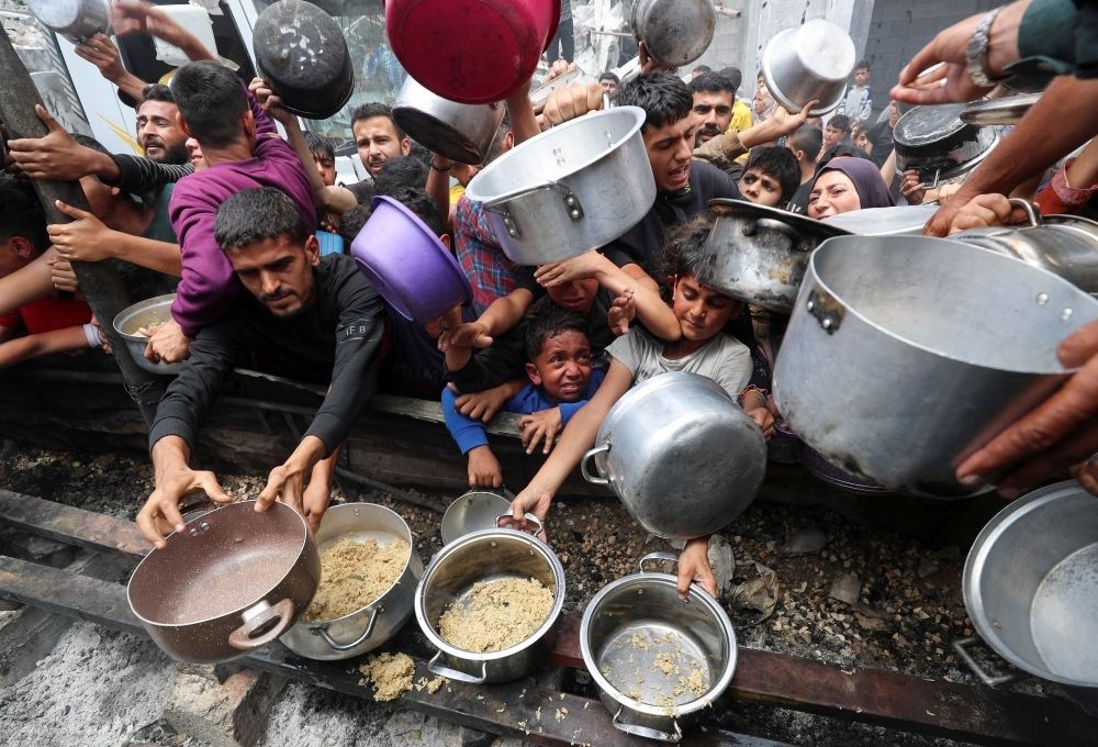 Israel finally allows limited food into Gaza after two months of blockade, but not before 57 children die of famine Palestinians wait to receive food cooked by a charity kitchen, in Jabalia, in the northern Gaza Strip, May 14, 2025. — Reuters pic