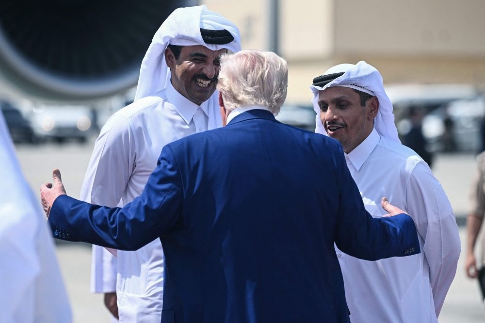 ‘Normal thing between allies’: Qatar PM dismisses claims of influence-buying over jet gift to Trump Qatar's Emir Sheikh Tamim bin Hamad al-Thani (left) and Prime Minister and Minister of Foreign Affairs Sheikh Mohammed bin Abdulrahman Al-Thani talk to US President Donald Trump as he prepares to leave at the end of the Qatari leg of his regional tour, at the Al-Udeid air base south-west of Doha May 15, 2025. — AFP pic