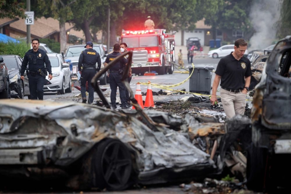 ‘The sky was orange’: Fiery plane crash in San Diego leaves multiple dead as jet fuel ignites neighbourhood Investigators look through the site where a small plane crashed into San Diego, California, residential street on May 22, 2025. The Federal Aviation Authority said a Cessna 550 crashed at around 3:45 am local time. — AFP pic
