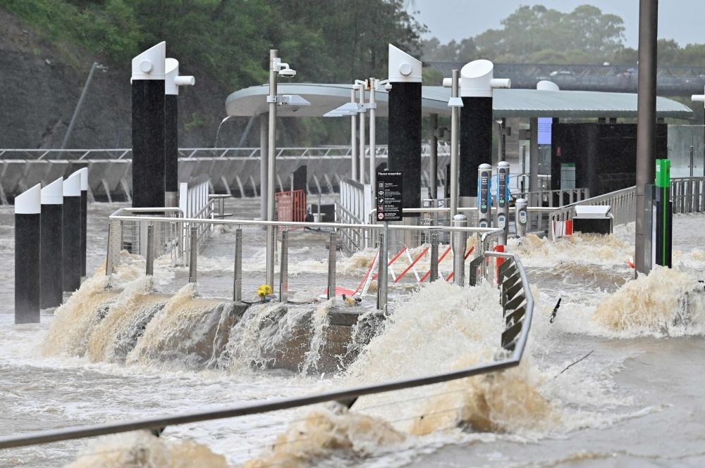 Flood water is seen flowing through Parramatta Wharf in Sydney on May 23, 2025. Record floods cut a destructive path through eastern Australia on May 23, caking houses in silt, washing out roads and separating 50,000 people from help. — AFP pic