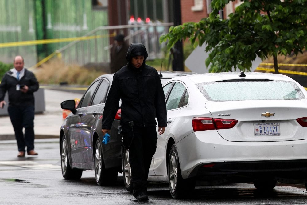 A crime scene technician walks where, according to the US Homeland Security Secretary, two Israeli embassy staff were shot dead near the Capital Jewish Museum in Washington, D.C. May 22, 2025. — Reuters pic