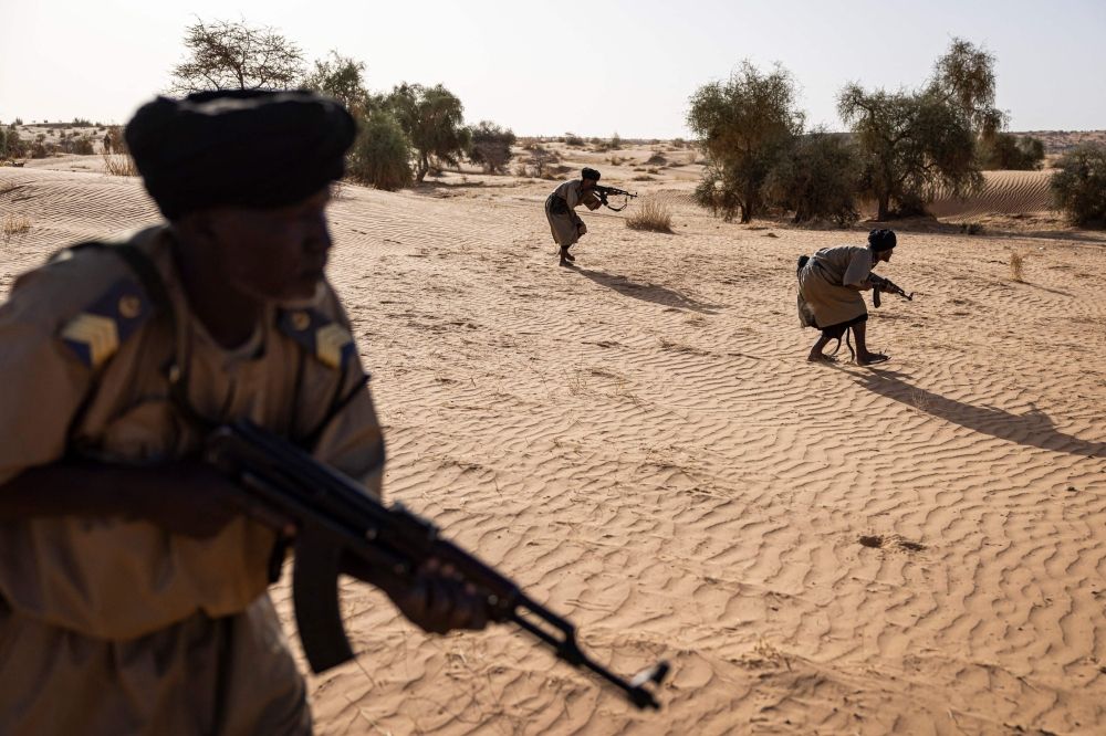 Members of the Mehariste National Guard unit approach a target during a training exercise in the Hodh Ech Chargui region, on April 7, 2025.