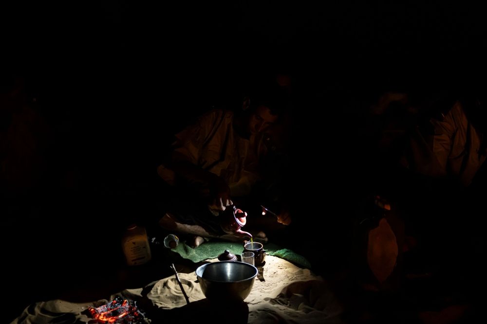 Member of the Mehariste National Guard unit Cheikh pours tea into a teapot after setting camp with his unit on the outskirts of Oualata April 6, 2025. — AFP ic
