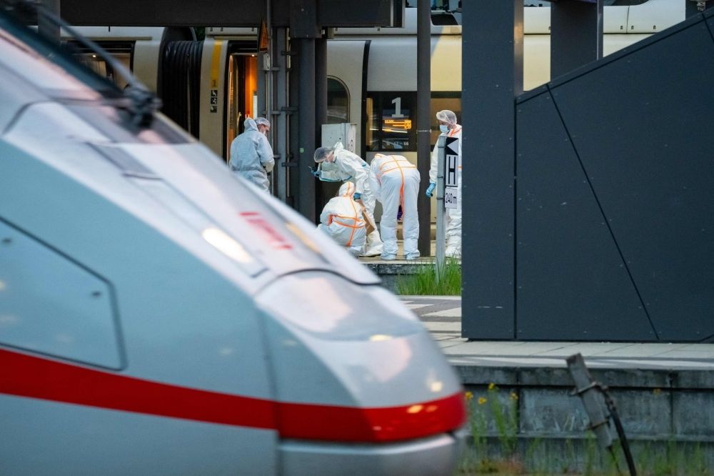 German woman faces court after Hamburg train station mass stabbing leaves 18 injured Forensic police officers investigate on the railway platform at Hamburg's main train station where at least 18 people have been injured in a knife attack May 23, 2025. — AFP pic