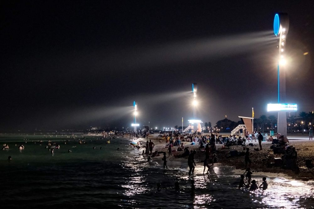 UAE bakes at 51.6°C as May heatwave scorches streets, strains air cons and stuns residents Floodlights bathe Dubai’s Umm Suqeim beach in light as residents seek relief from the heat after dark. — AFP pic