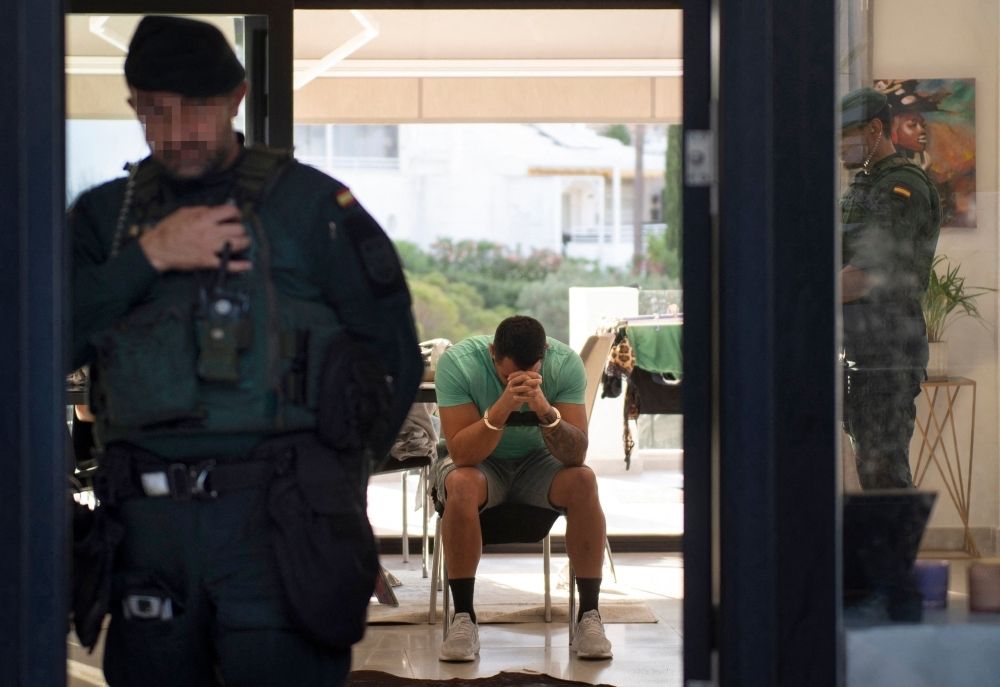 Sun, sand and suspects: How Spain seduces fugitive criminals Members of Spanish Guardia Civil, supported by Europol, arrest a man during an operation against drug trafficking in Mijas, near Malaga June 12, 2024. — AFP pic