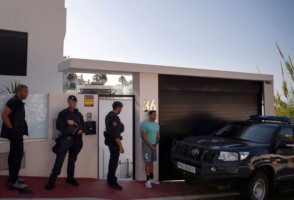 Members of Spanish Guardia Civil, supported by Europol, arrest a man during an operation against drug trafficking in Mijas, near Malaga June 12, 2024. — AFP pic