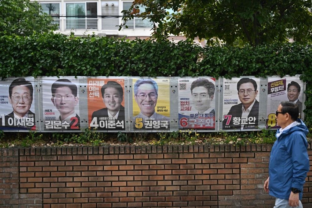 From fake Mao photos to AI deepfakes: How election disinformation is warping South Korea’s presidential race A man walks past banners showing South Korea’s presidential candidates ahead of the upcoming June 3 election. — AFP pic