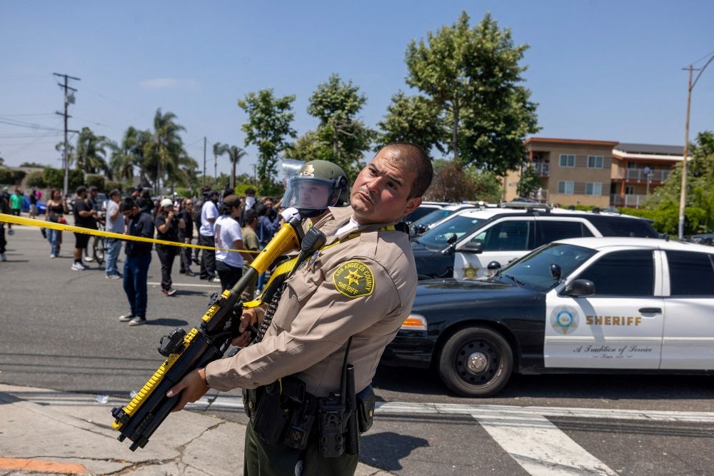 A Los Angeles County Sheriff’s deputy holds a non-lethal weapon during a standoff by protesters and law enforcement. — Reuters pic