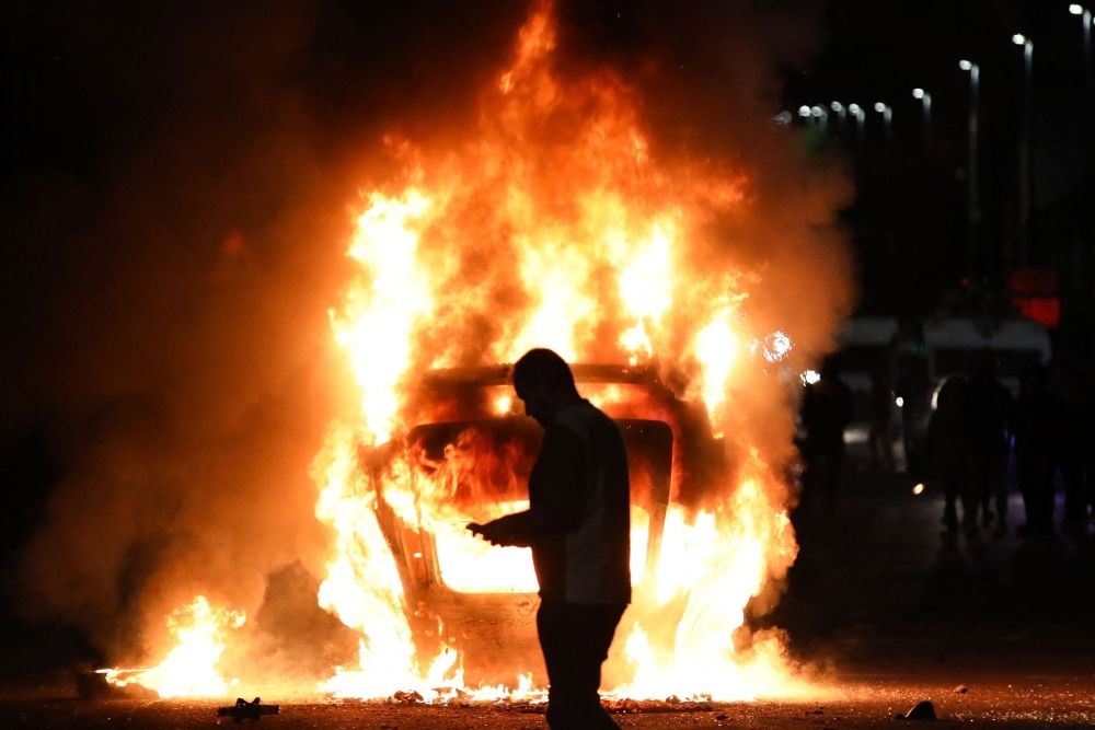Petrol bombs, fires and fear as racial tensions explode in Northern Ireland town following teen rape charges A vehicle is set alight during an anti-immigration demonstration in Ballymena, Northern Ireland, on June 10, 2025. Violence flared for a second night June 10 in the Northern Irish town of Ballymena after