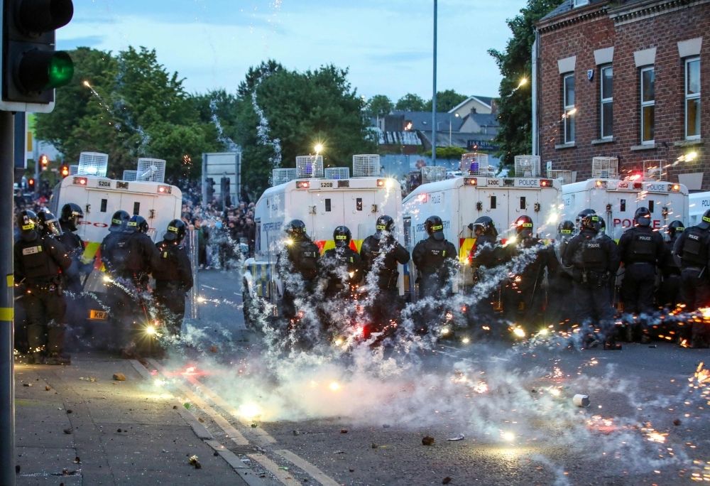 Third night of anti-immigrant violence hits Northern Ireland town as police face petrol bombs and protest Fireworks thrown at Riot Police illluminate the road during a thrid night of anti-immigration demonstrations in Ballymena, Northern Ireland yesterday. — AFP pic