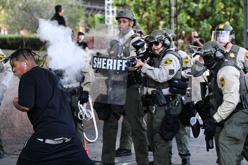 ‘Our city is not on fire’: LA residents push back against Trump’s rhetoric on protests amid military deployment Los Angeles County Sheriff's Department deputies fire a nonlethal weapon toward a man after he threw a can at them following a protest against federal immigration operations near Los Angeles City Hall in Los Angeles on June 11, 2025. — AFP pic