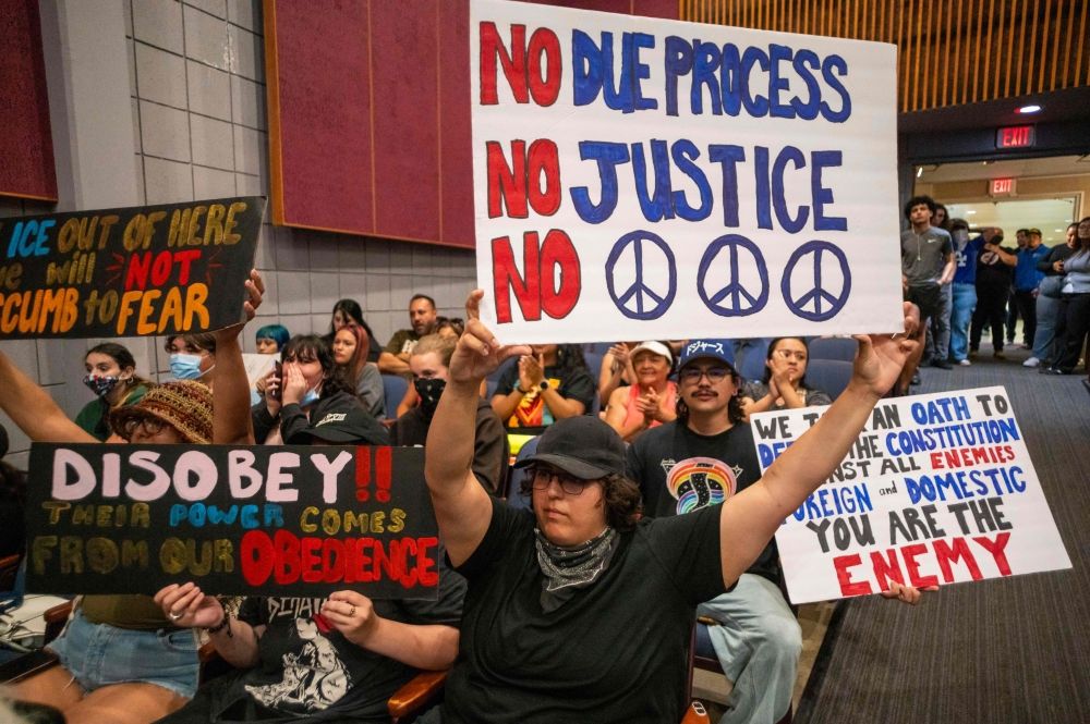 Demonstrators hold signs during a City Council meeting, demanding Immigration and Customs Enforcement (ICE) to be removed from the community, as demonstrations continue in response to federal immigration operations in the Whittier neighborhood of Los Angeles, California June 10, 2025. — AFP pic